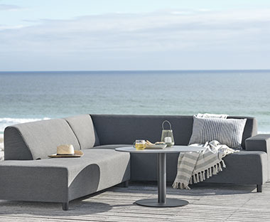 Wetterbeständiges Lounge-Sofa in Grau auf einer Terrasse